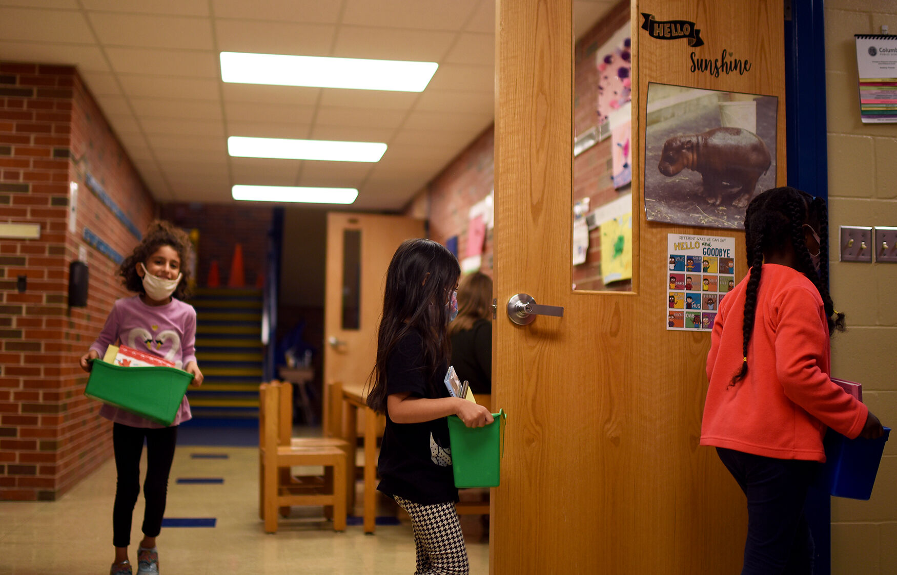 From left to right first grade students Nyah Saleh, Zoey Lam and Razan Ali return to